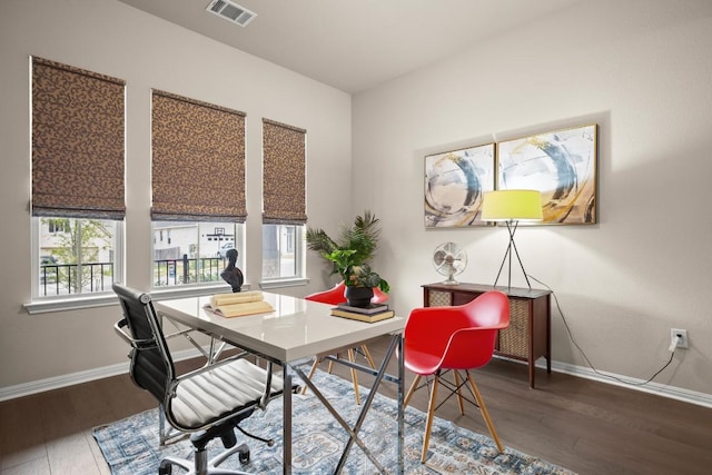 home office featuring a healthy amount of sunlight and dark hardwood / wood-style flooring