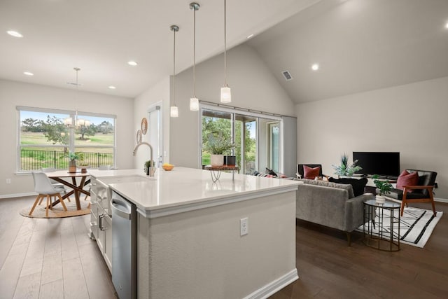 kitchen with dishwasher, white cabinets, dark hardwood / wood-style floors, an island with sink, and decorative light fixtures