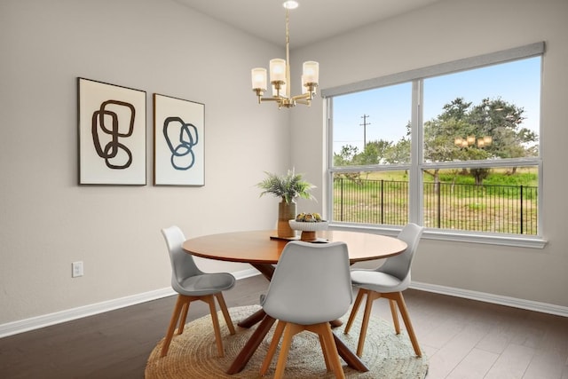 dining room featuring dark wood-type flooring and an inviting chandelier