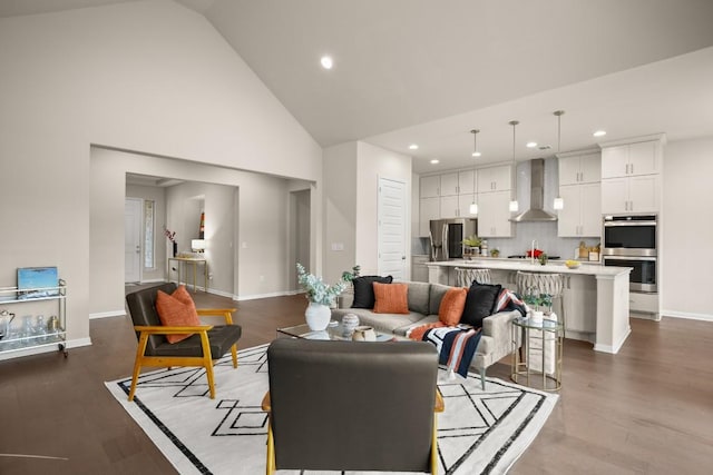 living room featuring high vaulted ceiling and light hardwood / wood-style flooring