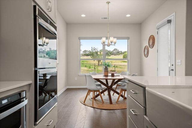 dining room with a notable chandelier and dark hardwood / wood-style flooring