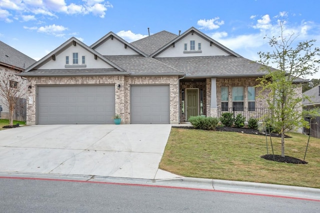 view of front of property with a garage and a front lawn