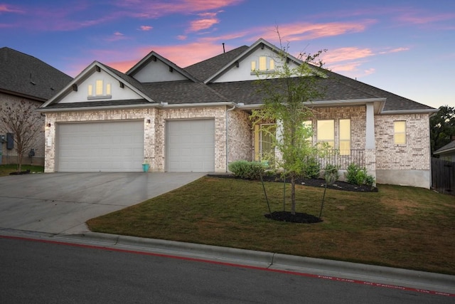 view of front facade with a lawn and a garage