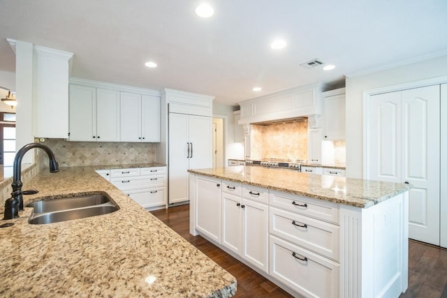 30102 Carmel Bay St, Georgetown, TX 78628 - kitchen featuring a center island, light stone counters, decorative backsplash, white cabinets, and recessed lighting