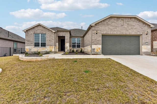 view of front of home featuring a front yard and a garage