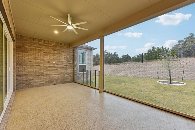 unfurnished sunroom with ceiling fan