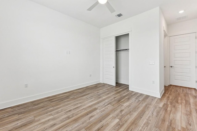 unfurnished bedroom featuring light wood-type flooring, a closet, and ceiling fan