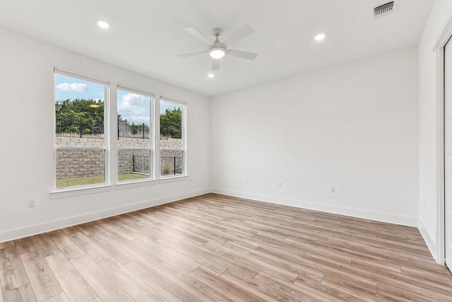 spare room with light hardwood / wood-style floors and ceiling fan