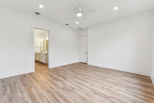 empty room featuring ceiling fan and light wood-type flooring