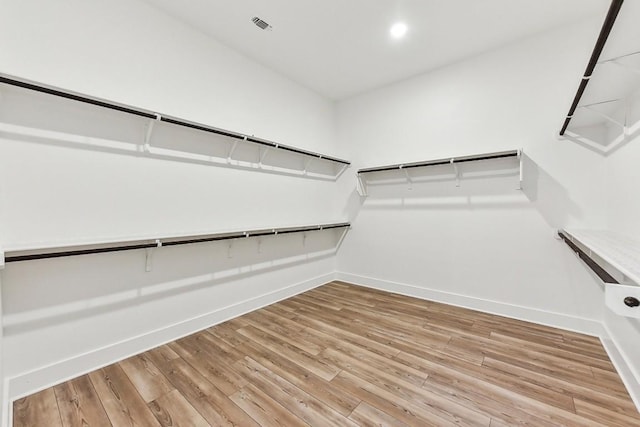 walk in closet with wood-type flooring