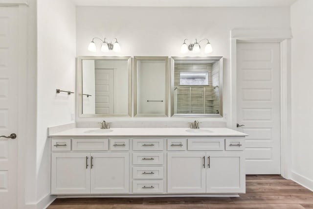 bathroom with vanity, wood-type flooring, and an enclosed shower