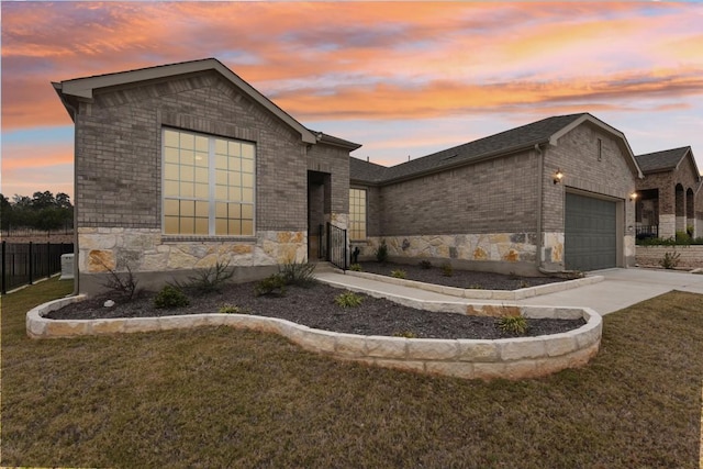 view of front of house with a yard and a garage