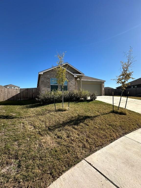 view of front of house featuring a garage and a front lawn