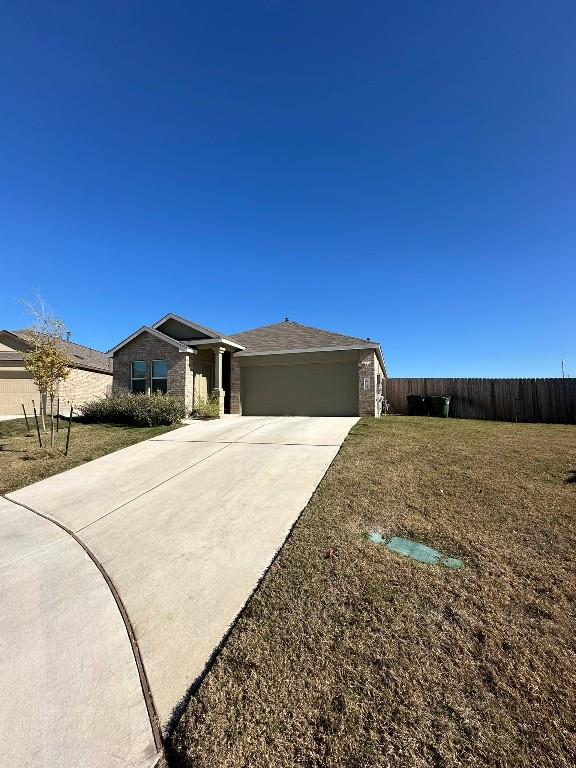 view of front of house featuring a front lawn and a garage