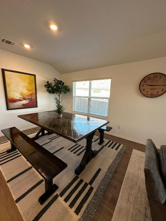 dining area with dark hardwood / wood-style flooring and lofted ceiling