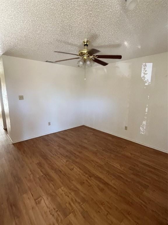 spare room featuring a textured ceiling, ceiling fan, and dark hardwood / wood-style floors