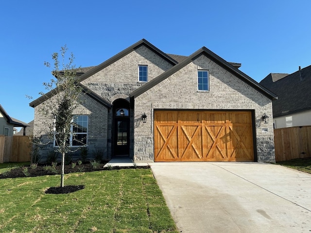 view of front of house featuring a front lawn and a garage