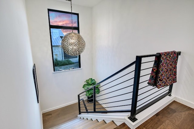 stairs featuring hardwood / wood-style floors