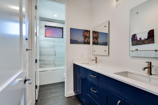 full bathroom featuring vanity, enclosed tub / shower combo, and toilet