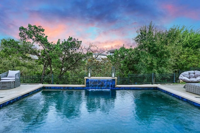 pool at dusk with pool water feature