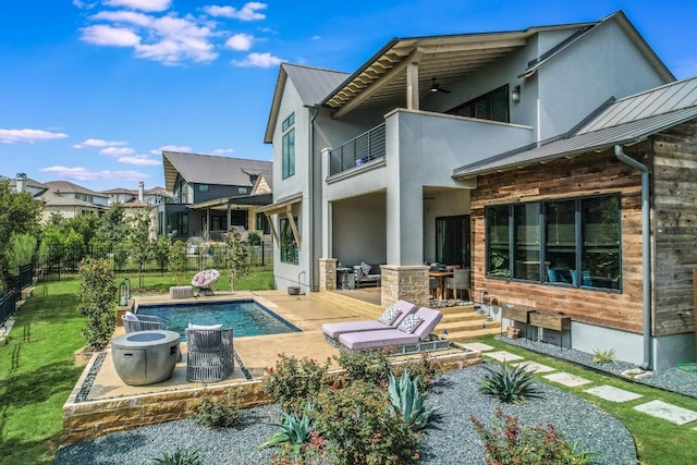 rear view of house with a patio area and a balcony