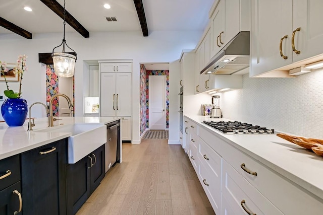 kitchen with beamed ceiling, backsplash, decorative light fixtures, white cabinets, and appliances with stainless steel finishes