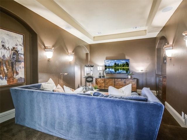 living room featuring a tray ceiling