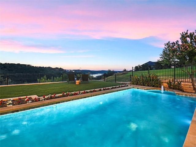 pool at dusk with a lawn