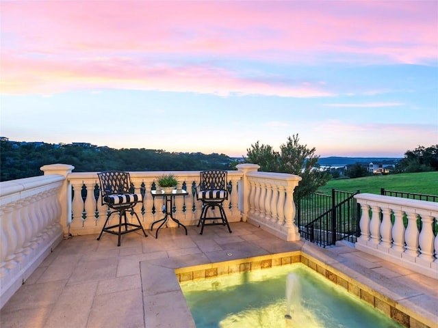 pool at dusk with a jacuzzi