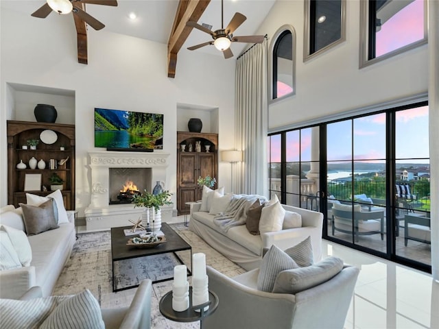 tiled living room with beam ceiling, ceiling fan, and a high ceiling