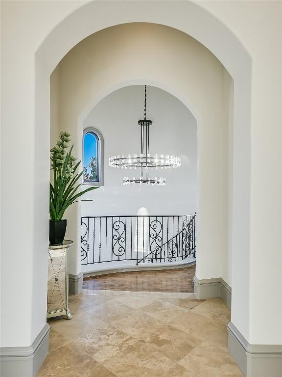 corridor with an inviting chandelier