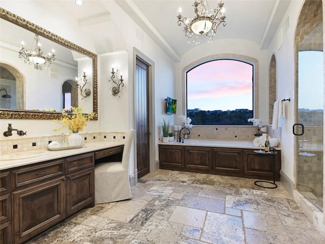 bathroom featuring vanity, backsplash, independent shower and bath, and a chandelier