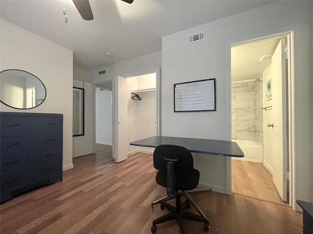 office with hardwood / wood-style flooring and ceiling fan