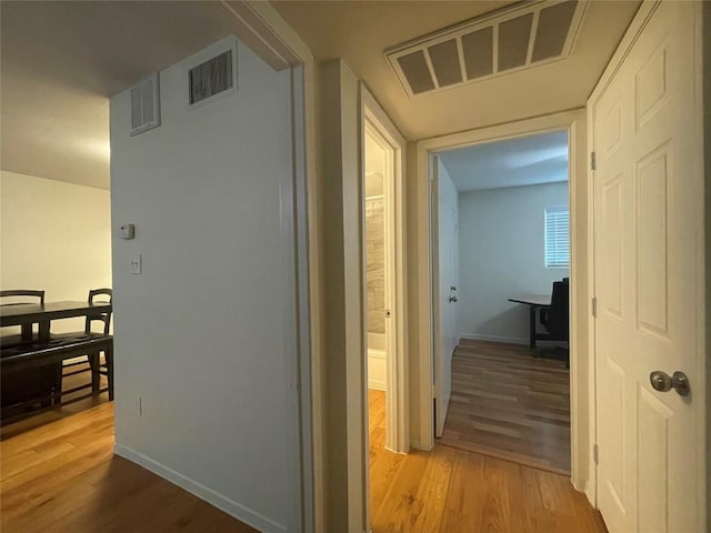 hallway with hardwood / wood-style floors