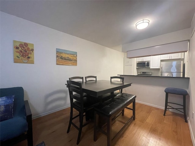 dining space featuring light wood-type flooring