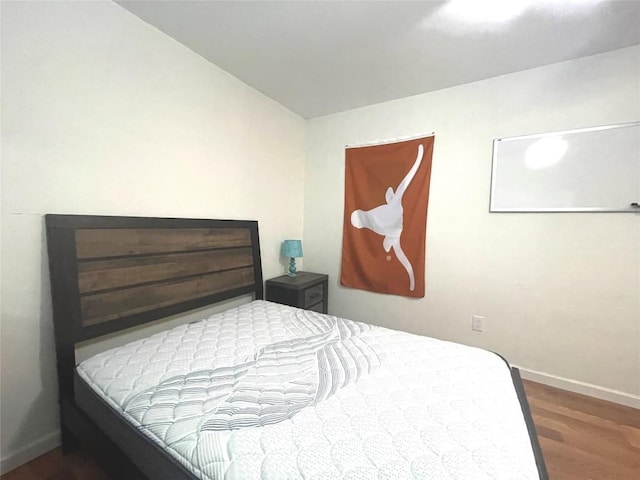 bedroom with dark wood-type flooring