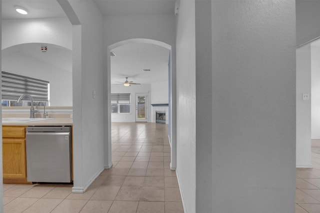 hallway with sink and light tile patterned flooring