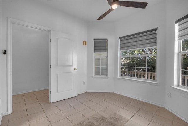 spare room with light tile patterned floors and ceiling fan