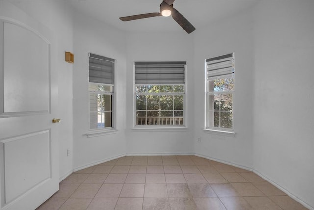 empty room with light tile patterned floors and ceiling fan