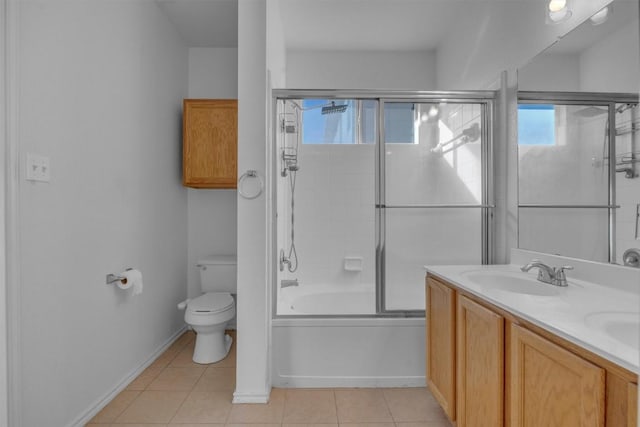 full bathroom featuring tile patterned floors, vanity, toilet, and bath / shower combo with glass door