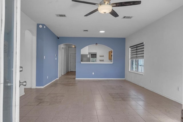 unfurnished living room featuring ceiling fan and light tile patterned floors