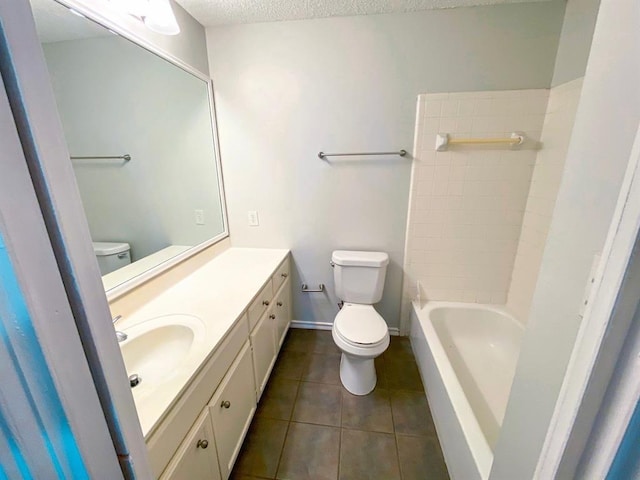 bathroom featuring tile patterned flooring, vanity, a textured ceiling, and toilet