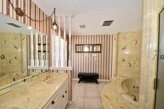 bathroom featuring tile patterned floors, a tub, and vanity