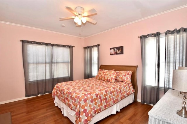 bedroom with ceiling fan, crown molding, and dark wood-type flooring