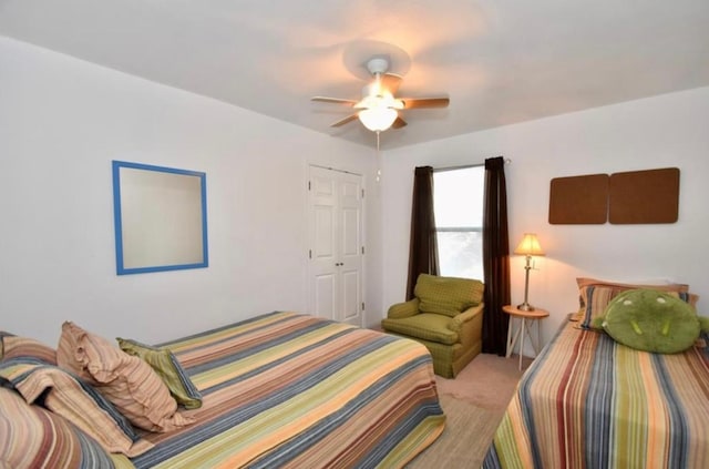 carpeted bedroom with a closet and ceiling fan