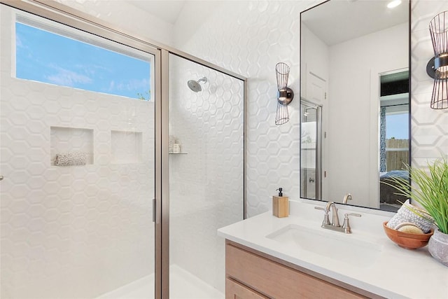 bathroom featuring vanity and a shower with shower door