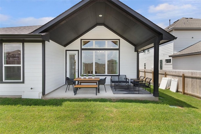 back of house featuring an outdoor living space, a yard, and a patio