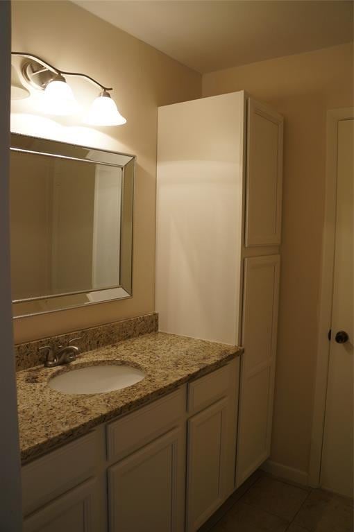 bathroom with tile patterned floors and vanity