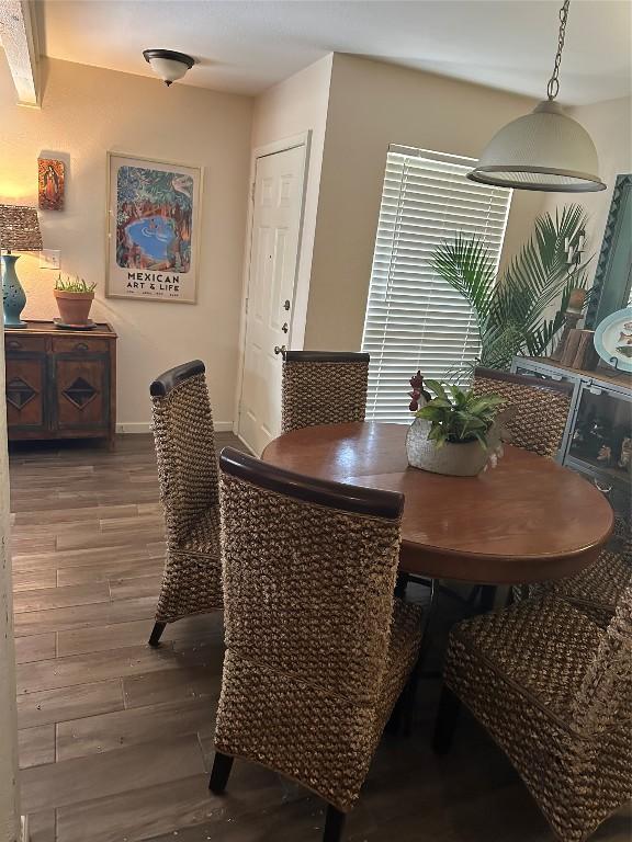 dining room with dark wood-style floors and baseboards