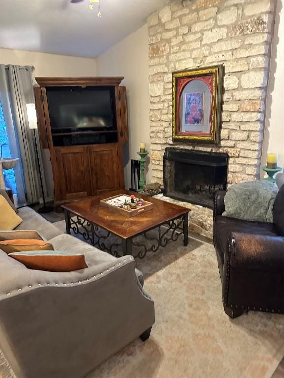 living area featuring vaulted ceiling and a fireplace